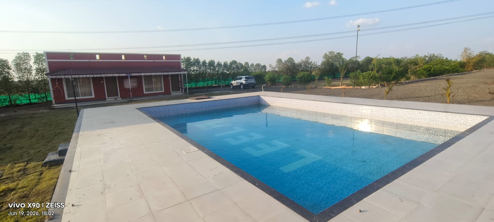 Pool with cottages in daylight